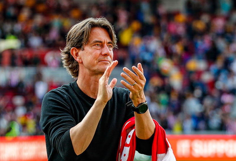 Brentford Football Club manager Thomas Frank celebrates home win at Gtech Community Stadium with scarf