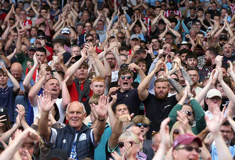 Brentford Football Club fans celebrate and clap goal